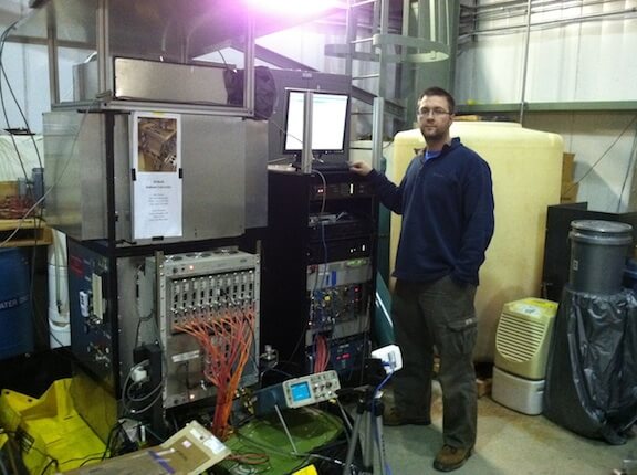 An image of Dr. Robert Cooper in front of some machinery